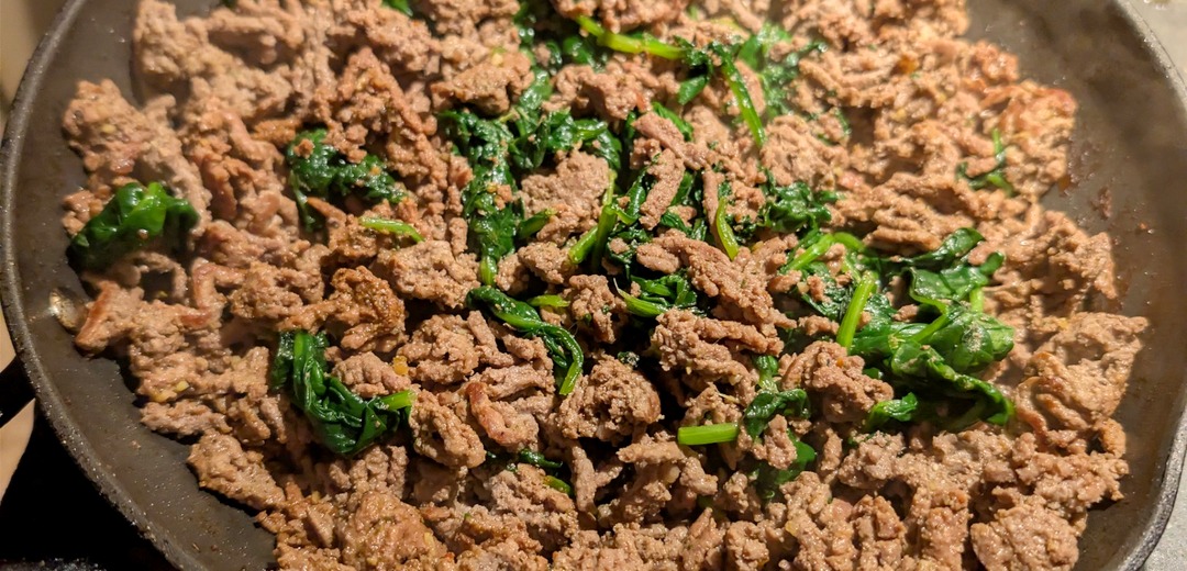 Herb-spiced lean ground beef cooked down with spinach